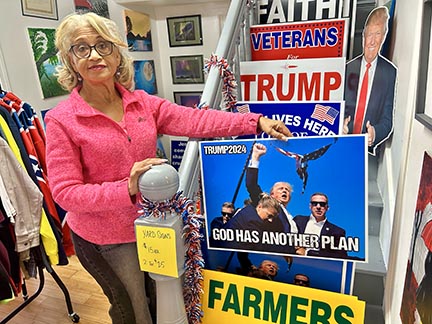 Jo Anne Price displays some of the signs at the Trump Store.