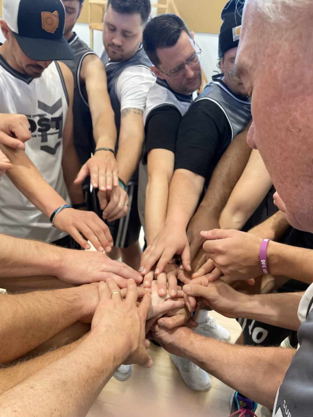 3 28 long White and Grey Teams pray before the game. scaled
